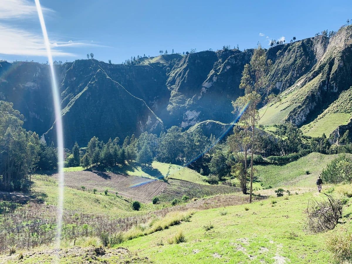 A broad green valley cut by a river